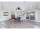 Inviting sunroom features brick floors, neutral walls, and a cozy fireplace, ideal for entertaining at 13625 Se 93Rd Court Rd, Summerfield, FL 34491