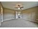 Large bedroom with neutral walls, ceiling fan, and carpet floors at 14442 Sw 19Th Pl, Ocala, FL 34481