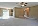 Spacious living room showcasing an open layout, neutral carpet, and bright natural light at 14442 Sw 19Th Pl, Ocala, FL 34481