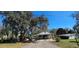 Home exterior with trees, a covered porch, and shed on the property at 14805 Se 51St Ct, Summerfield, FL 34491