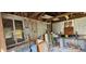 Interior of outbuilding with shelving, pegboard, work table, and many windows at 14805 Se 51St Ct, Summerfield, FL 34491