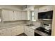 Well-lit kitchen with stainless steel appliances and white countertops at 14805 Se 51St Ct, Summerfield, FL 34491