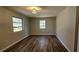 Well-lit living room with wooden floor and natural light creating a welcoming space at 14805 Se 51St Ct, Summerfield, FL 34491