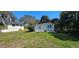 Exterior of the backyard outbuilding with wood siding and double doors, with a house in the background at 14805 Se 51St Ct, Summerfield, FL 34491