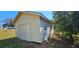 Exterior view of shed with siding and a roll-up door at 14805 Se 51St Ct, Summerfield, FL 34491