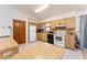 Well-lit kitchen features wooden cabinets, white appliances, and ceramic tile flooring at 1912 Se 169Th Ct, Silver Springs, FL 34488