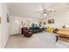 Cozy living room featuring a leather recliner, sofa, and bright natural light through the window at 1912 Se 169Th Ct, Silver Springs, FL 34488