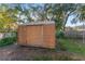 Wooden shed in backyard providing practical and versatile storage at 1912 Se 169Th Ct, Silver Springs, FL 34488