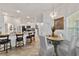 Cozy dining area adjacent to the kitchen, featuring a modern chandelier and large windows at 3925 Ne 58Th Cir, Silver Springs, FL 34488