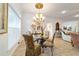 Elegant dining area with designer light fixture and decor elements at 3925 Ne 58Th Cir, Silver Springs, FL 34488