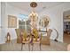 Formal dining room with glass table, chandelier, and luxurious details at 3925 Ne 58Th Cir, Silver Springs, FL 34488