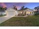 Front exterior view of single-story home featuring a well-manicured lawn and an attached two-car garage at 3925 Ne 58Th Cir, Silver Springs, FL 34488