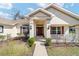 Inviting front porch featuring a decorative walkway, stylish pillars, and complementary landscaping at 3925 Ne 58Th Cir, Silver Springs, FL 34488