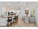 Bright kitchen and dining area with stainless appliances, breakfast bar and modern light fixture at 3925 Ne 58Th Cir, Silver Springs, FL 34488