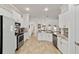 Bright kitchen featuring white cabinetry, stainless steel appliances, and granite countertops at 3925 Ne 58Th Cir, Silver Springs, FL 34488