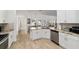 Well-lit kitchen with island, tile backsplash, and stainless steel dishwasher at 3925 Ne 58Th Cir, Silver Springs, FL 34488