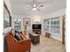 Comfortable living room featuring a leather sofa, modern decor, and ample natural light at 3925 Ne 58Th Cir, Silver Springs, FL 34488