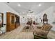 Elegant living room with tile floors, a decorative ceiling fan, and sophisticated furnishings for relaxing and entertaining at 3925 Ne 58Th Cir, Silver Springs, FL 34488