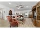 Well-lit living room featuring a large window, stylish furnishings, and tile flooring at 3925 Ne 58Th Cir, Silver Springs, FL 34488