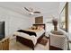 Well-lit main bedroom with a ceiling fan, closet, dresser, mirror, area rug and window at 3925 Ne 58Th Cir, Silver Springs, FL 34488