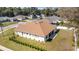 Rear exterior view of a home with a well-manicured lawn, showcasing its spacious backyard and patio area at 3925 Ne 58Th Cir, Silver Springs, FL 34488