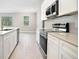 Bright white kitchen with stainless steel appliances, quartz counters and wood look floors at 5095 Sw 158Th St, Ocala, FL 34473