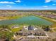 Aerial view of the community showcasing the clubhouse, lake, and surrounding residential area at 6185 Sw 89Th Ct, Ocala, FL 34481