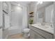 Bathroom featuring a tub-shower combo, vanity, and decorative floating shelves at 6185 Sw 89Th Ct, Ocala, FL 34481