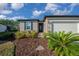 Beautiful front yard with lush landscaping leading to the charming home at 6185 Sw 89Th Ct, Ocala, FL 34481