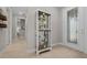 Inviting hallway with wood-look tile, decorative shelving and a leaded glass front door at 6185 Sw 89Th Ct, Ocala, FL 34481