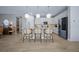 The island kitchen has an island with pendant lights and seating and stainless appliances at 6185 Sw 89Th Ct, Ocala, FL 34481