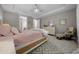 Main bedroom with a tray ceiling, dresser, sitting area, and ensuite bathroom access at 6185 Sw 89Th Ct, Ocala, FL 34481