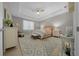 Bright main bedroom features a tray ceiling, cozy bench, and neutral decor at 6185 Sw 89Th Ct, Ocala, FL 34481