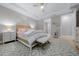 Cozy main bedroom featuring a tray ceiling, neutral decor, and ample natural light at 6185 Sw 89Th Ct, Ocala, FL 34481