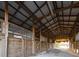 Bright barn interior with wood stalls and open design, excellent for livestock at 6890 Nw 21St St, Ocala, FL 34482