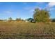 Rural barn with lush field and wooden fence, surrounded by mature trees, offering country charm at 6890 Nw 21St St, Ocala, FL 34482