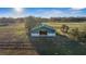 Aerial view of horse barn with fenced pastures, providing a picturesque setting for equestrian activities at 6890 Nw 21St St, Ocala, FL 34482