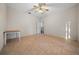 Bedroom featuring tile floors, ceiling fan, and view into the kitchen, creating a functional and inviting space at 6890 Nw 21St St, Ocala, FL 34482