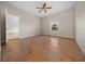 Bright bedroom featuring laminate wood floors, a ceiling fan, and neutral colored walls at 6890 Nw 21St St, Ocala, FL 34482