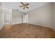 Open bedroom featuring laminate wood floors, a ceiling fan, and neutral colored walls at 6890 Nw 21St St, Ocala, FL 34482