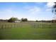 Expansive green pasture land with wood fencing and scattered trees, ideal for horses or livestock at 6890 Nw 21St St, Ocala, FL 34482