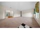 Spacious living room with neutral carpet, a decorative chandelier and an open layout at 6890 Nw 21St St, Ocala, FL 34482