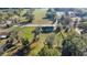 Aerial view of a gray home set on a spacious, grassy lot with surrounding trees and foliage at 7010 Nw 44Th Ave, Ocala, FL 34482