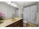 Bathroom featuring vanity with solid surface counters and shower with curtain at 7010 Nw 44Th Ave, Ocala, FL 34482