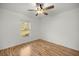 Bedroom with wood floors, window overlooking a backyard and ceiling fan at 7010 Nw 44Th Ave, Ocala, FL 34482