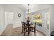 Inviting breakfast nook filled with light from exterior windows and updated light fixture at 7010 Nw 44Th Ave, Ocala, FL 34482