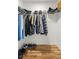 Walk-in closet with wire shelving, hanging clothes and wood-look flooring at 7010 Nw 44Th Ave, Ocala, FL 34482