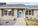 Charming home featuring a light blue front door, decorative shutters, and landscaped walkway at 7010 Nw 44Th Ave, Ocala, FL 34482