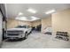 Spacious garage featuring a white pickup truck, ample lighting, and storage solutions at 7010 Nw 44Th Ave, Ocala, FL 34482