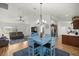 Bright living room featuring modern lighting, vaulted ceilings, and sleek wood flooring at 7010 Nw 44Th Ave, Ocala, FL 34482